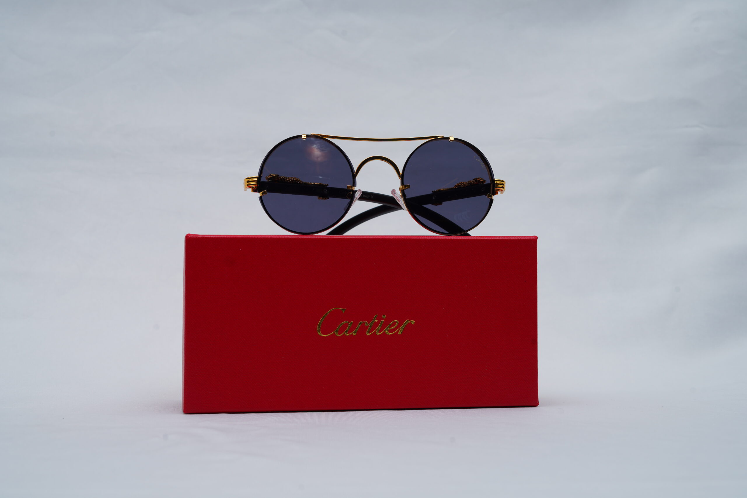 Cartier Unisex Panthère Rimless Round Sunglasses in Dark Grey Lenses and Gold Frame