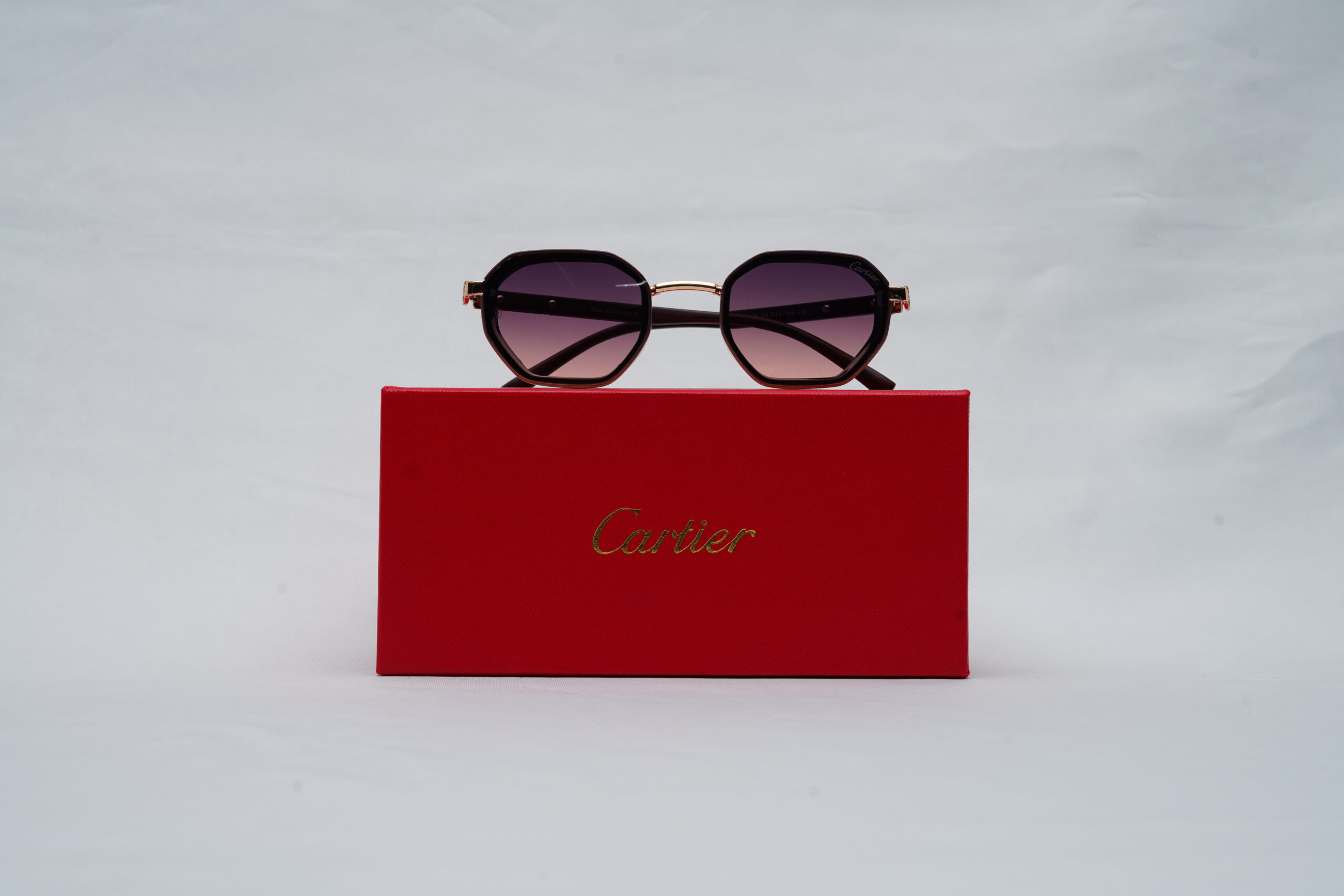 Cartier Full-Rim Hexagonal Sunglasses – Black Acetate with Gold Bridge and Purple Gradient Lenses