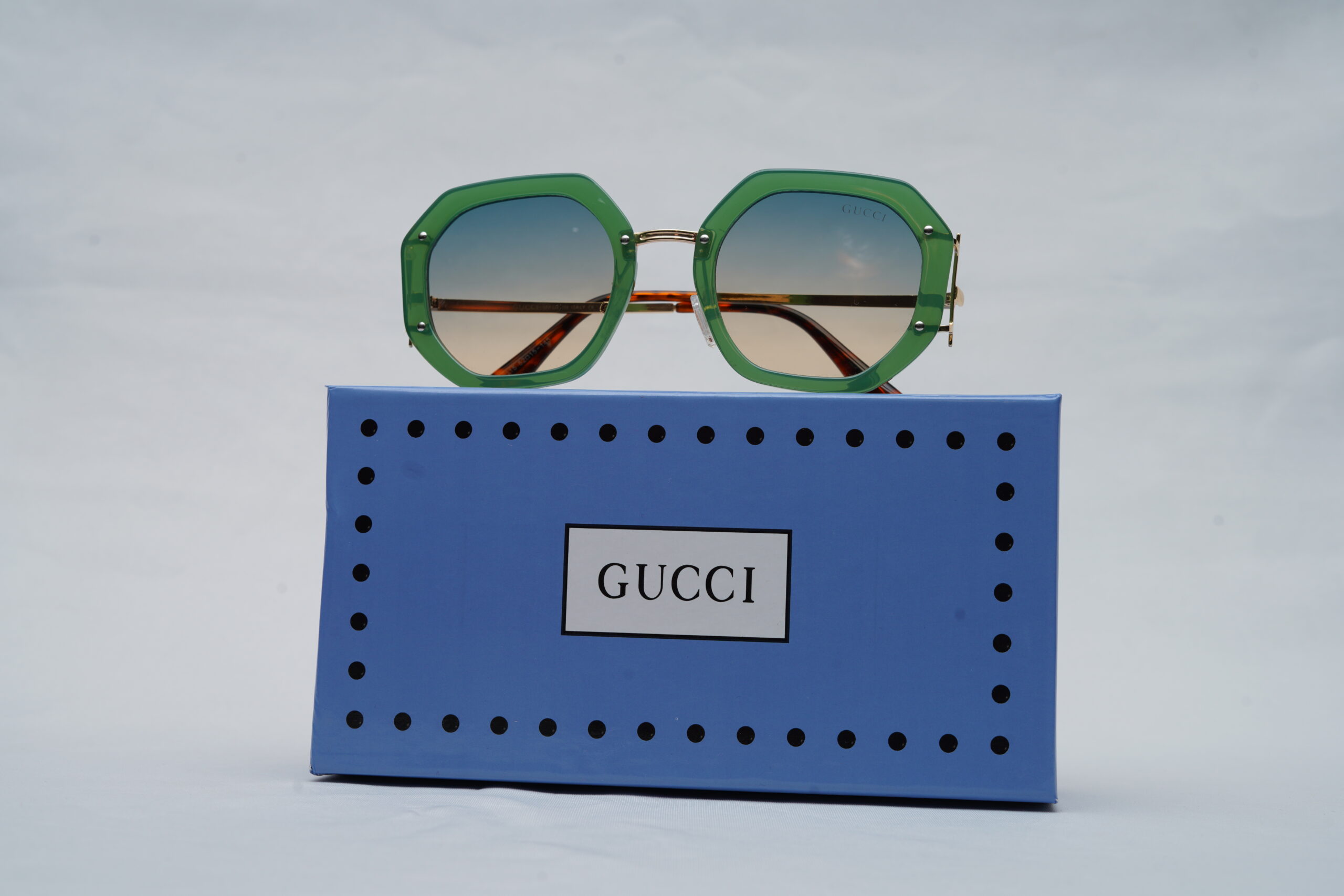 Gucci Full-Rim Geometric Sunglasses – Emerald Green and Gold with Blue-to-Peach Gradient Lenses